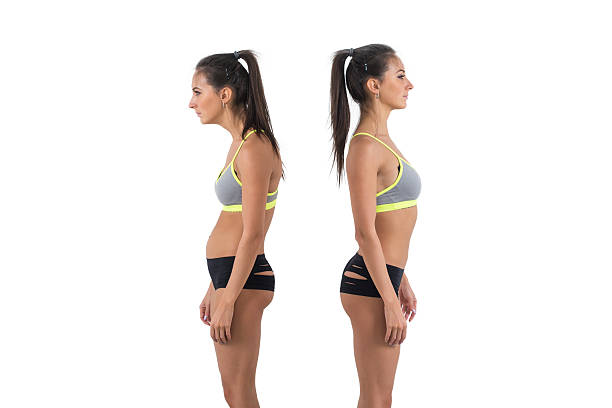 Person demonstrating neutral standing posture beside a window